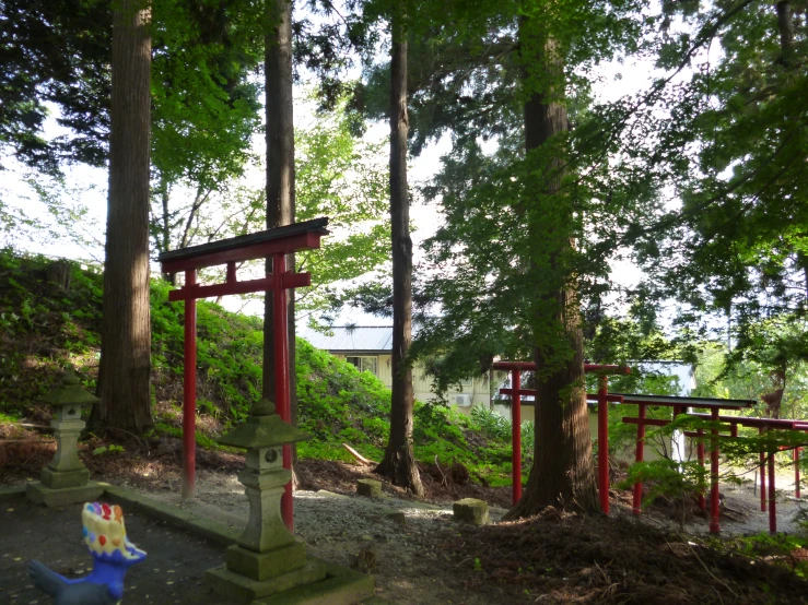 a statue in the woods with an interesting sculpture