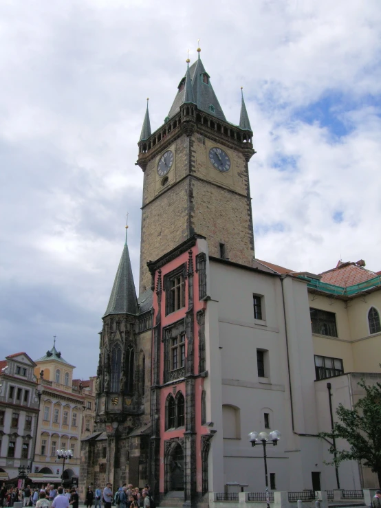 a church with a massive clock tower in the middle of a town