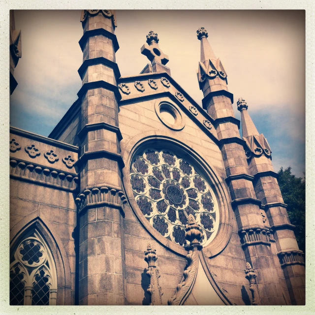 an old po of a church steeple with a rose - centered window