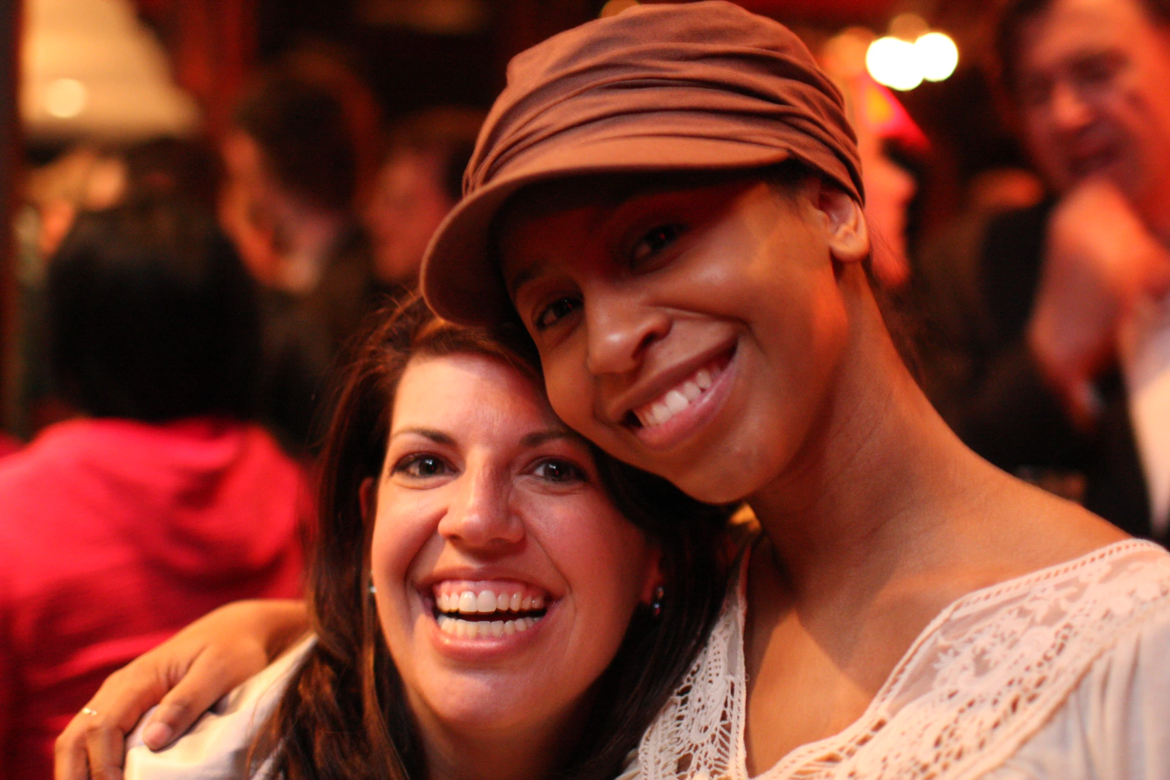 a woman taking a selfie with her friend at a bar