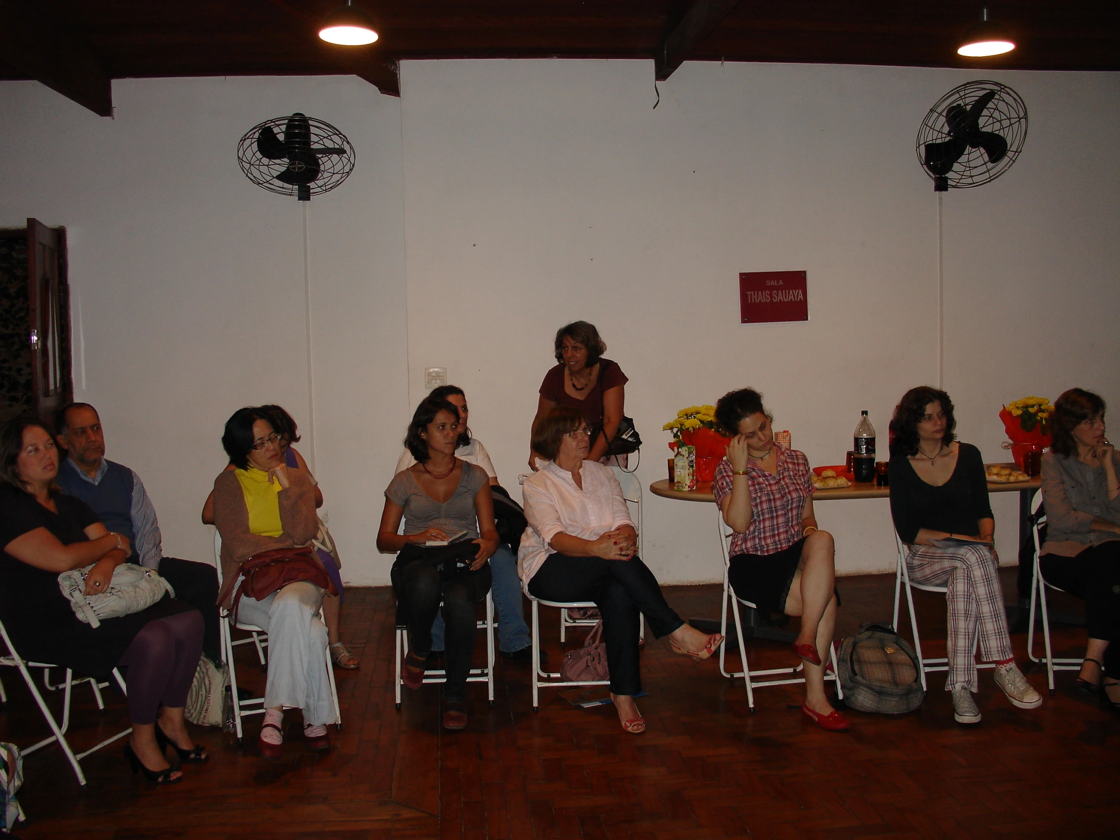 a group of women sitting and standing in chairs