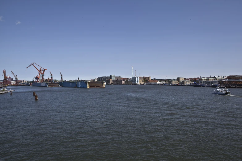 two boats are on the water near docks