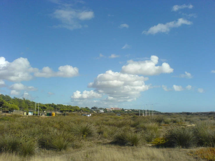 there is a sky with clouds that are over the ground