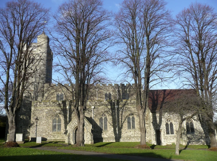 a stone church is surrounded by trees and grass