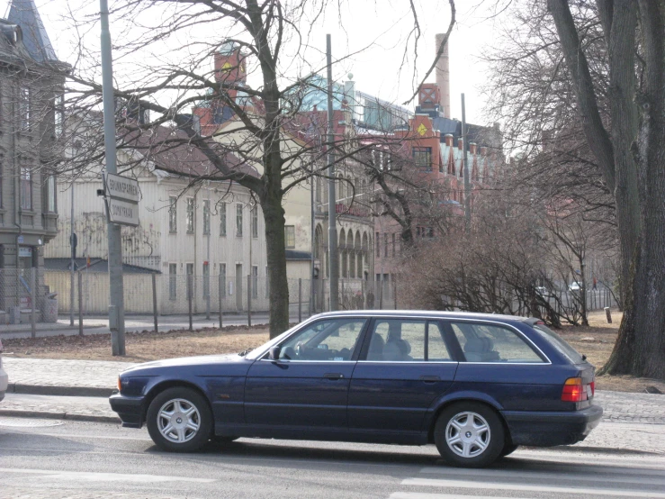 a blue car is stopped at the light