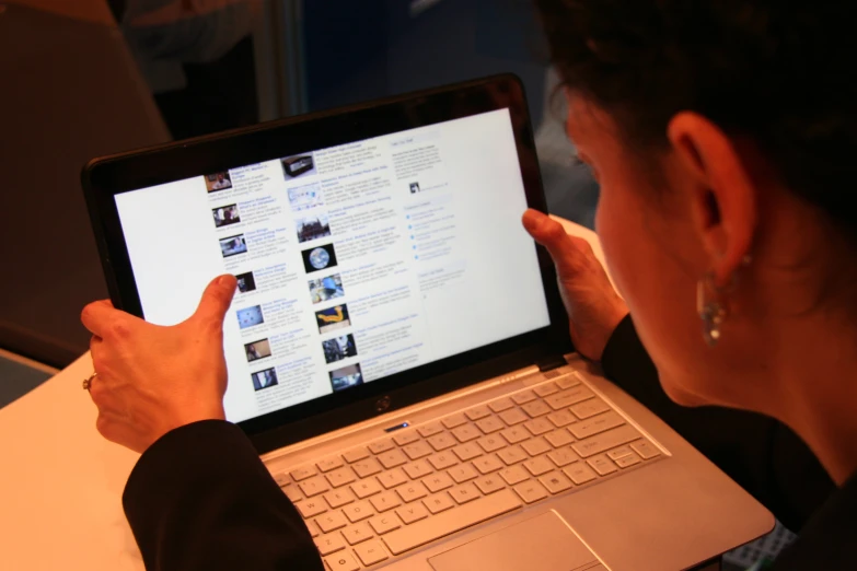 a woman using a laptop computer on a desk