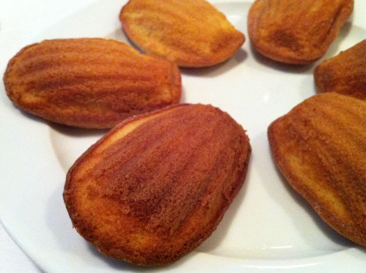 several almonds sitting on top of a white plate