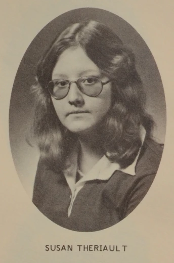a black and white po of a woman wearing glasses