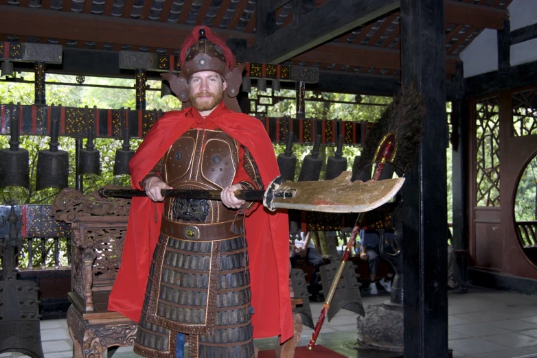 a man in medieval garb holding a sword