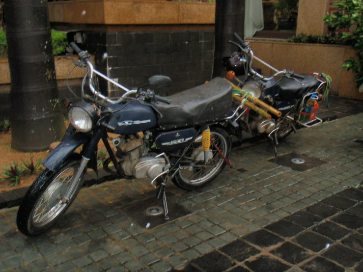 an old motor cycle is parked on a street