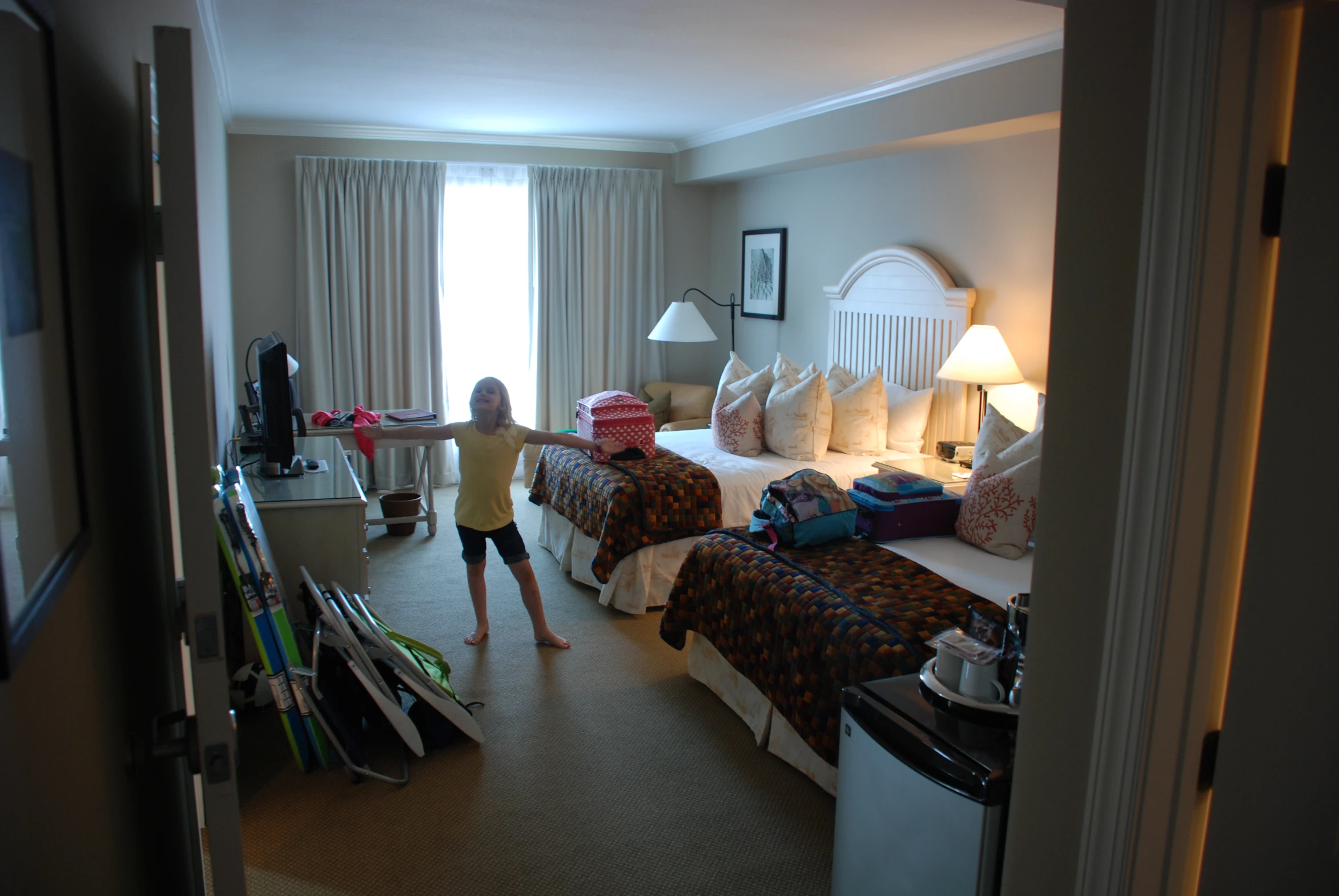 a bedroom filled with beds covered in lots of pillows