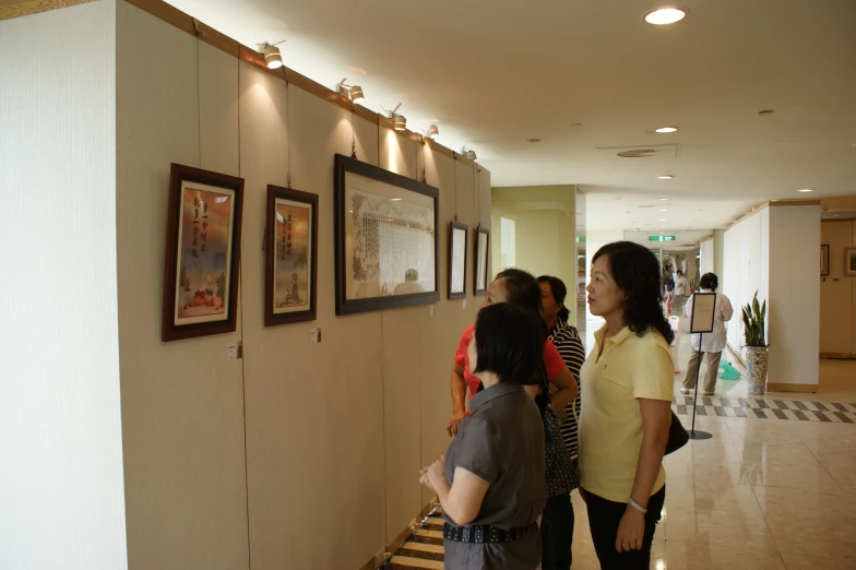 a group of people walking through a lobby