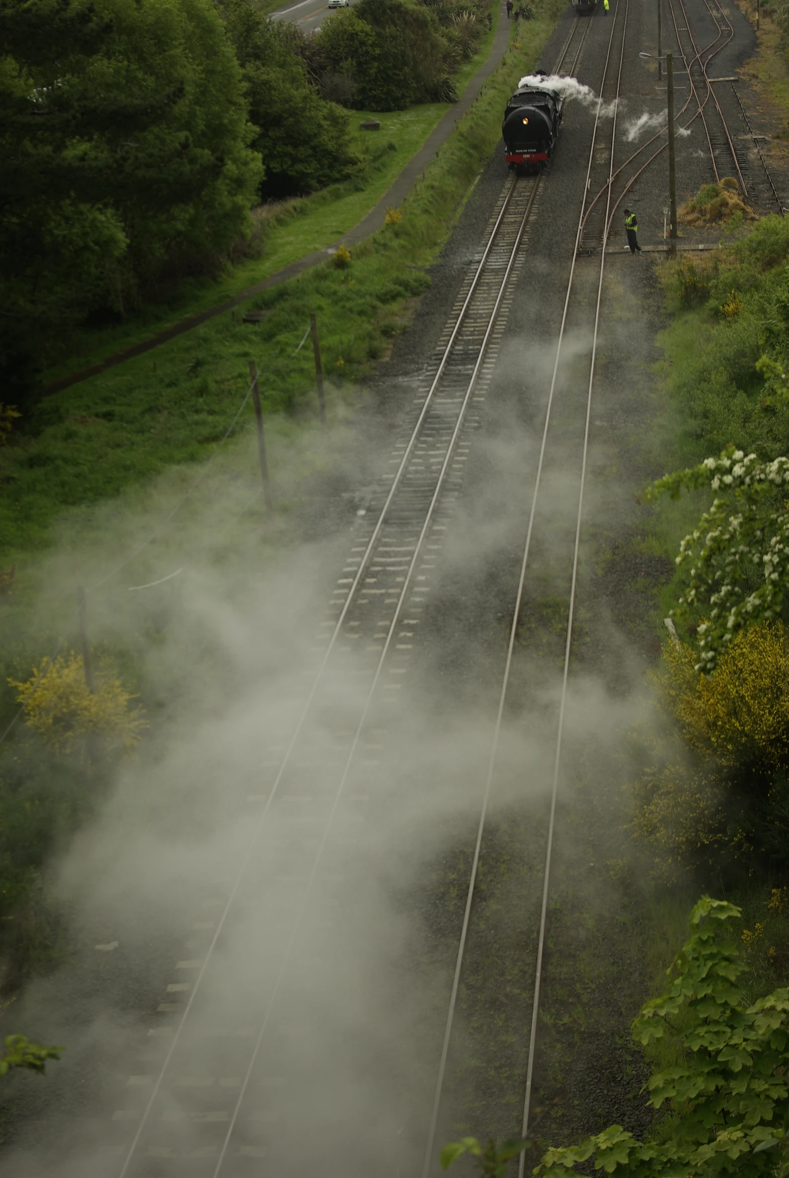 two trains on a train track near a field