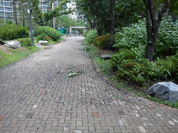 a walk way with brick streets and grass
