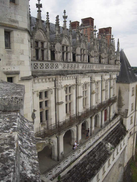 a very old building with a couple of people standing outside