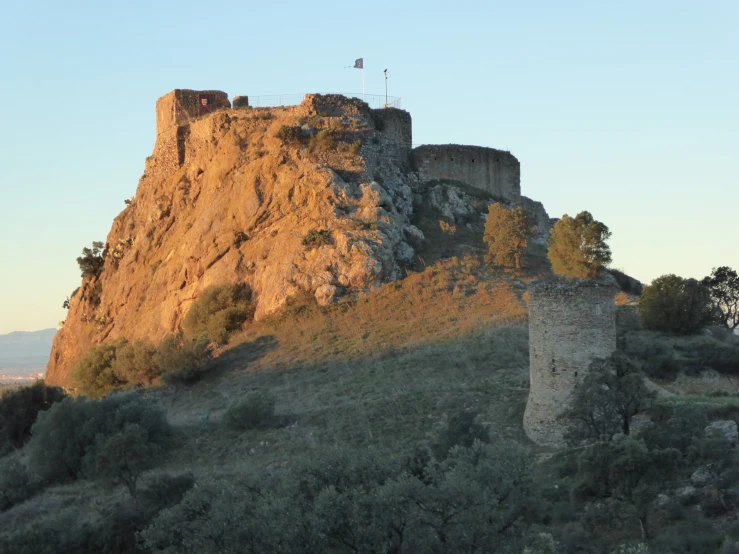 a castle in the mountain with tall walls