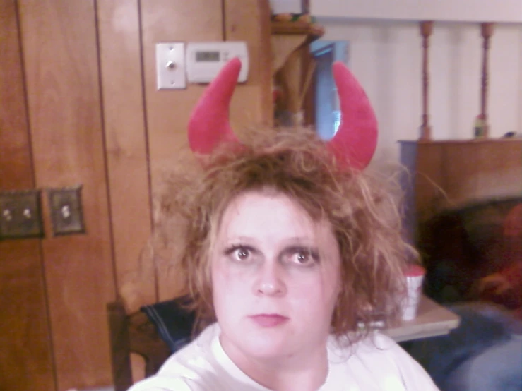 woman wearing devilish hair with red horns on her head