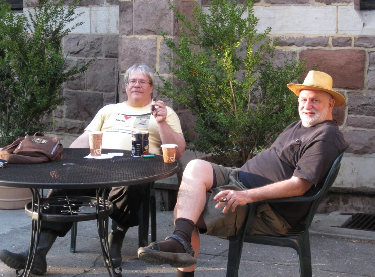 an old man and a woman sitting at a small table