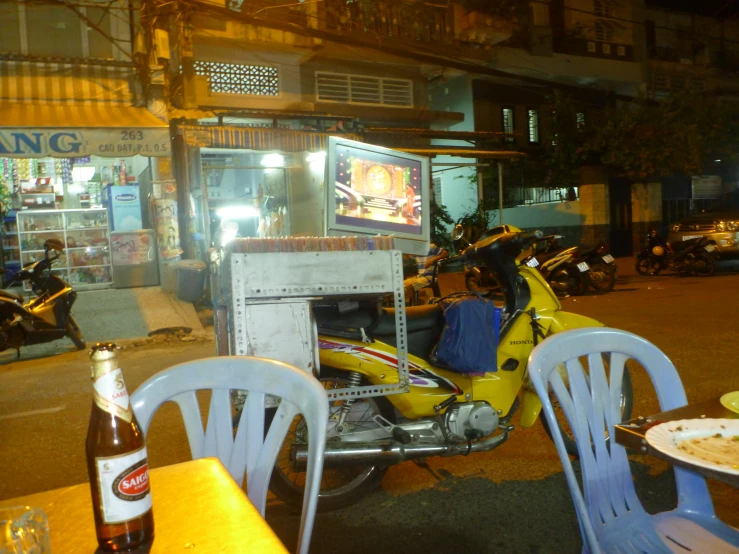 an oriental food stand at night with many tables set up