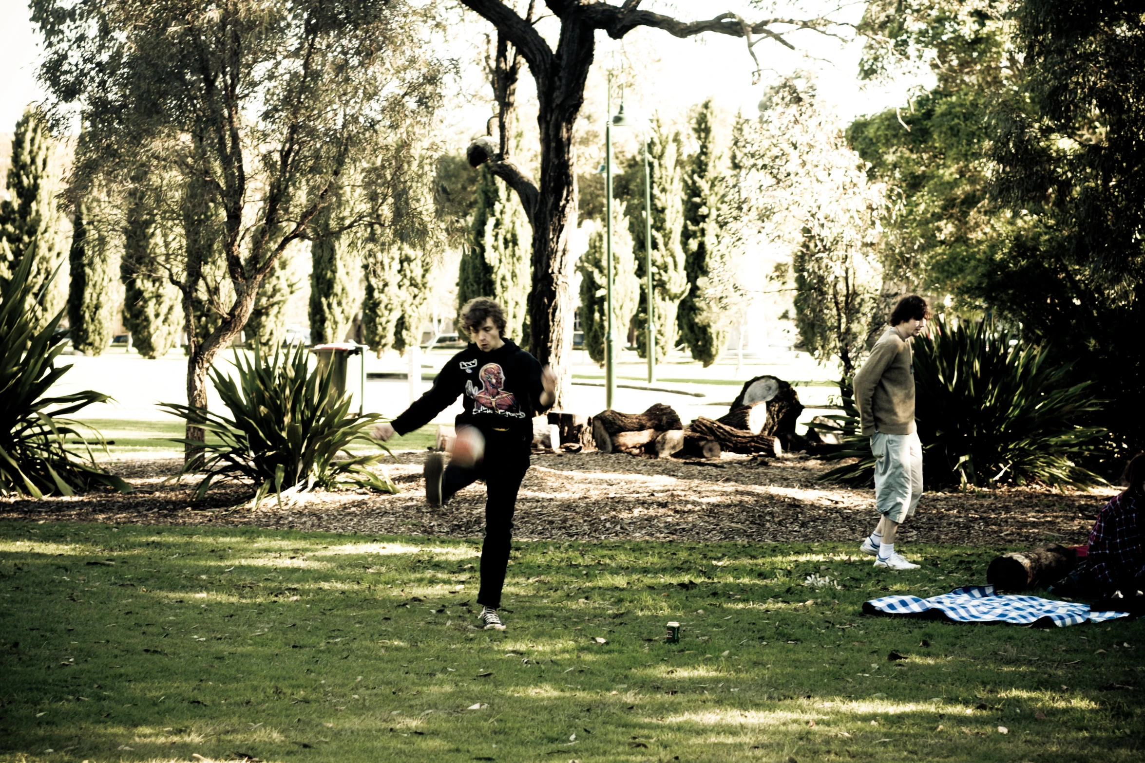 two people playing with a frisbee in the grass