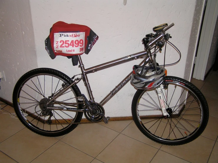 this is the back of a silver bicycle with the number twenty - five attached