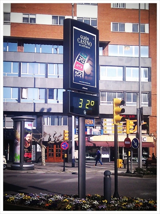 a parking sign on a city street next to tall buildings