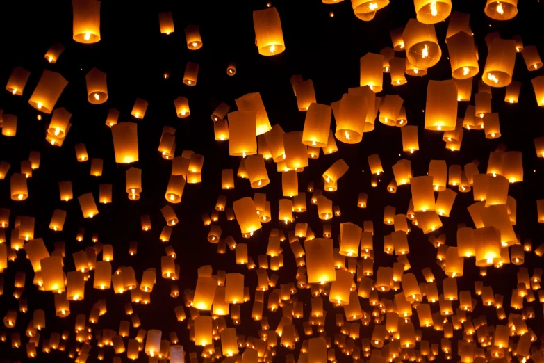 there are hundreds of large and small paper lanterns flying