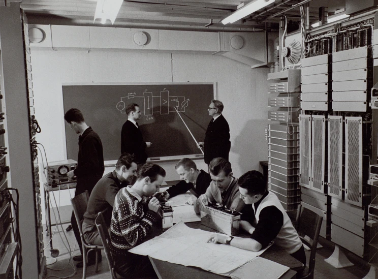 a group of young men looking at a blackboard in an old - fashioned room