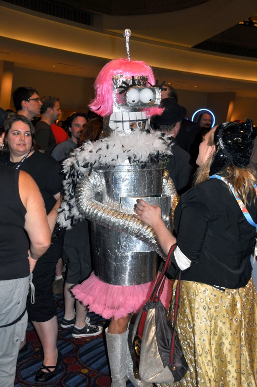 a costumed robot standing in a hallway of people