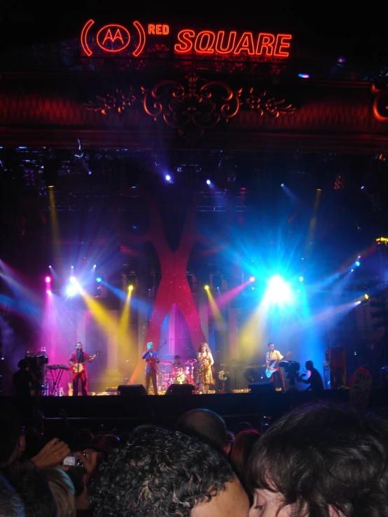 an audience at a concert watching band perform