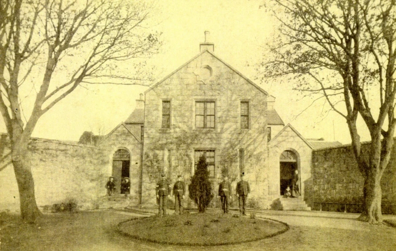 some people are standing in front of a stone building