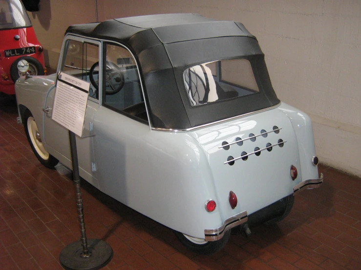 this small white car is on display at the museum