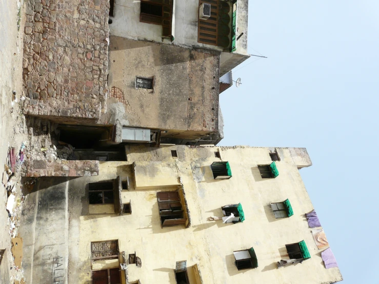 an old building is shown with green windows