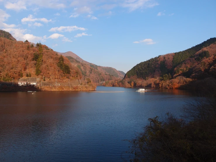 a small boat is going on a large river