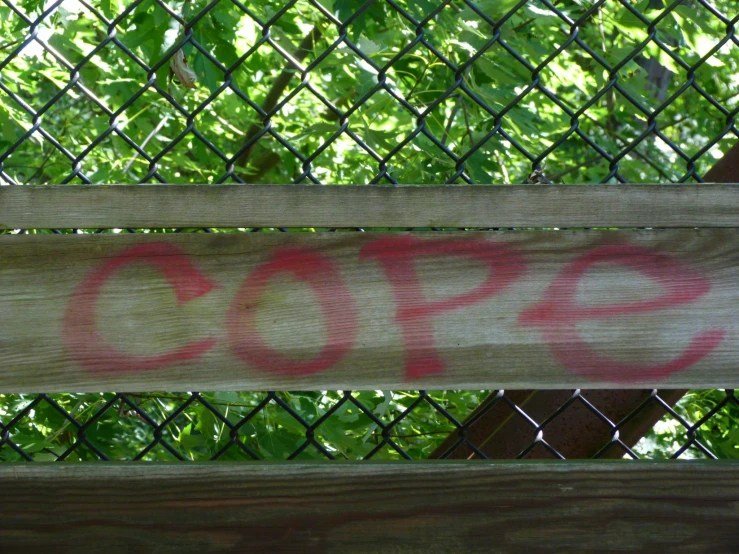 the word stop painted on a wood bench