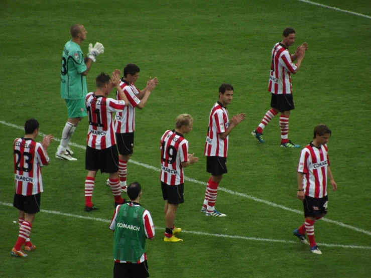 a team of soccer players on the field together