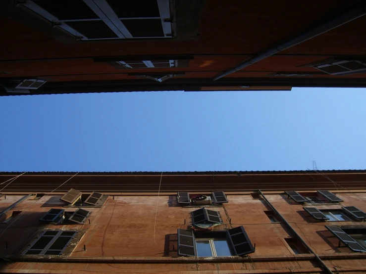 an old building with many windows in front of a blue sky