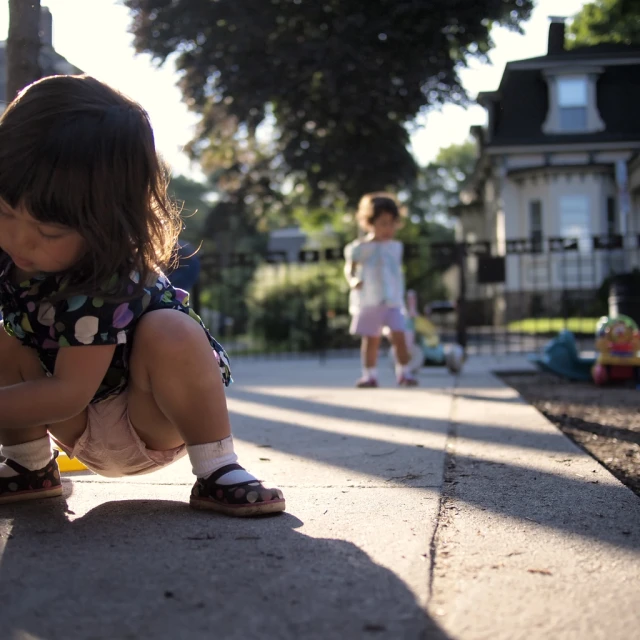 a young child playing with his toy at a park