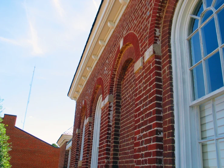 an old brick building has many windows and trim