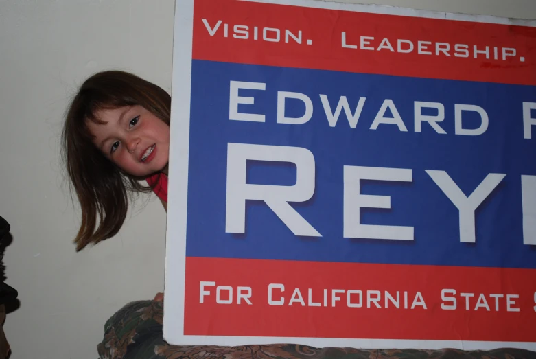 a  standing in front of a red and blue sign