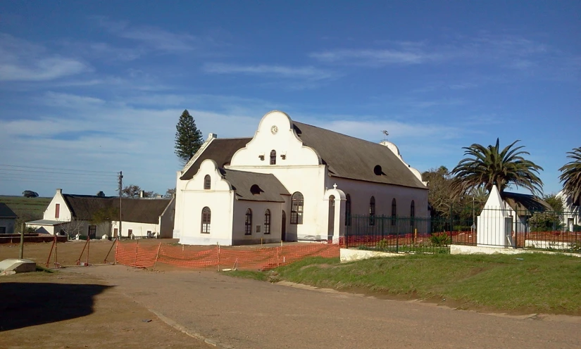 the church has a white, two story tower and a black roof