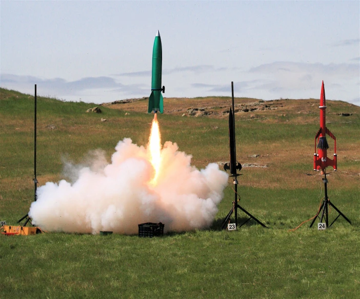 a jet launching an missile on the grass