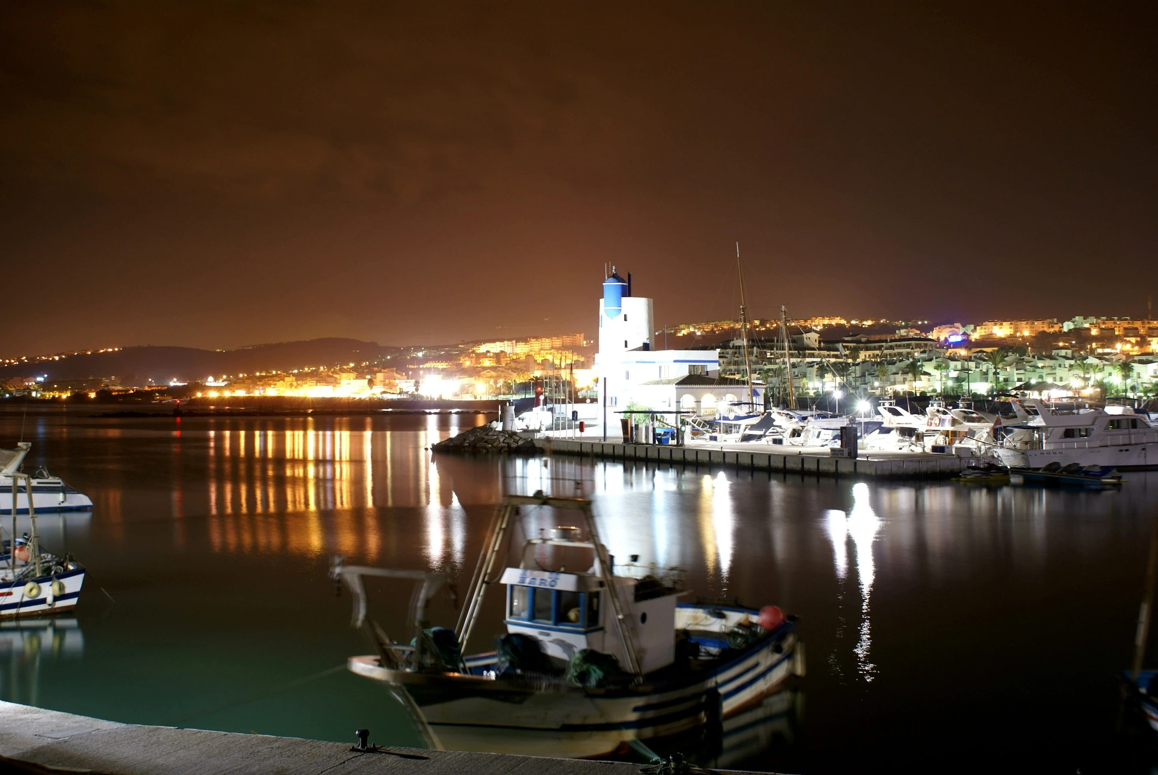 boats are sitting at the dock in the harbor