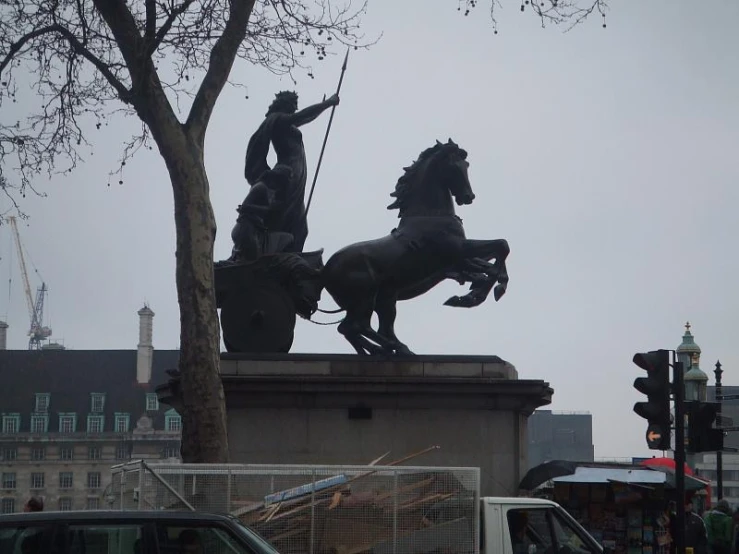 a statue of a man on a horse in a street