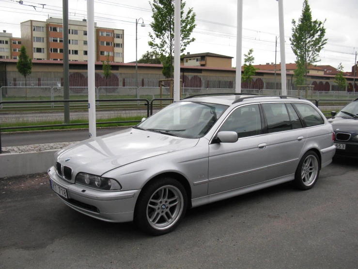 an silver car is sitting on the side of the road