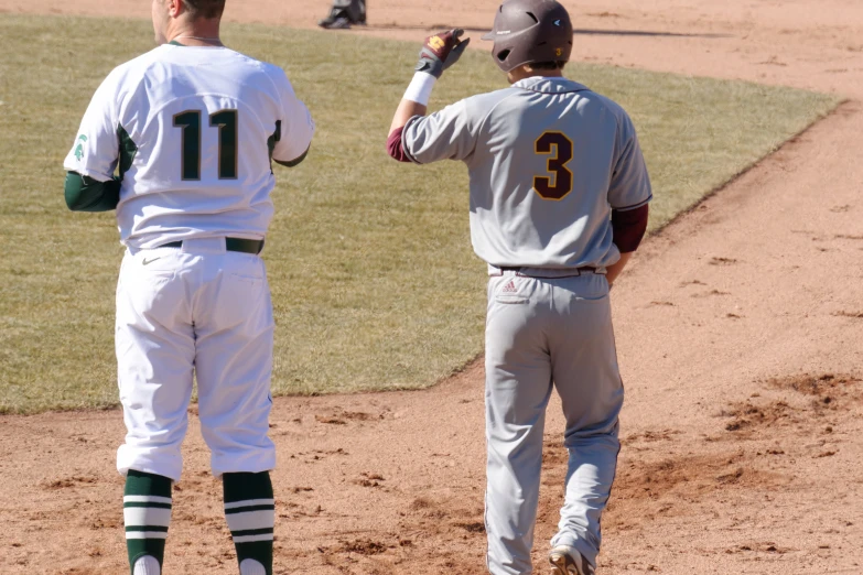 two baseball players on a baseball diamond talking