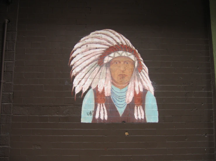 a picture of an indian on a brick wall