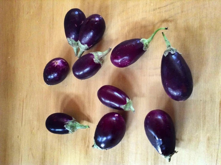 nine eggplant on a wooden table all cut up