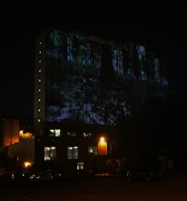 a large building has a very large lighted screen