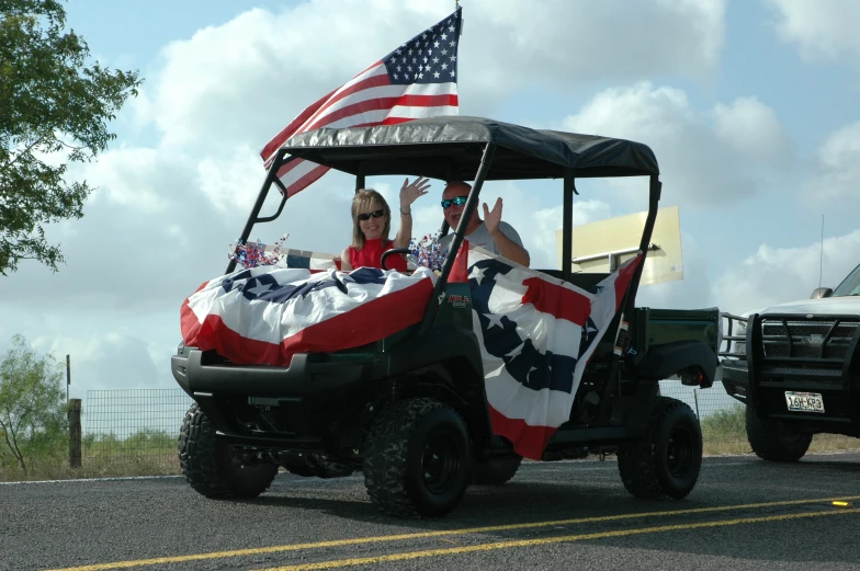 a man drives a golf cart in the street